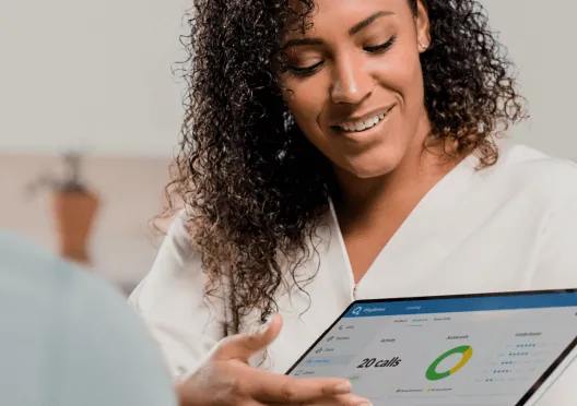 A sales representative showing sales data from her tablet