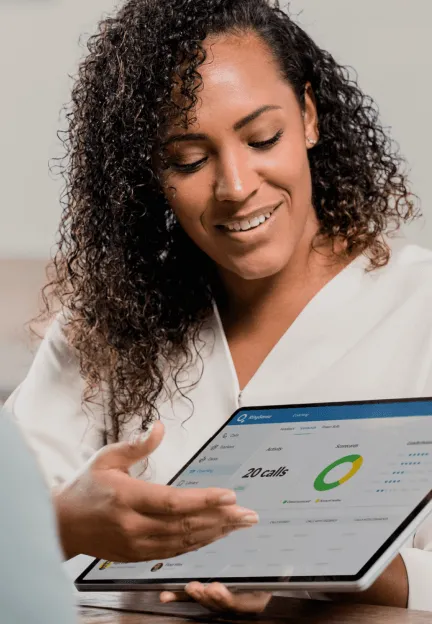A sales representative showing sales data from her tablet