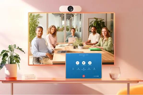 An in-office call using RingCentral Rooms, displayed on a conference room monitor and tablet.