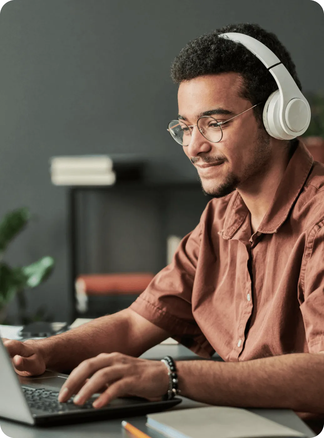 A bespectacled man with headphones on