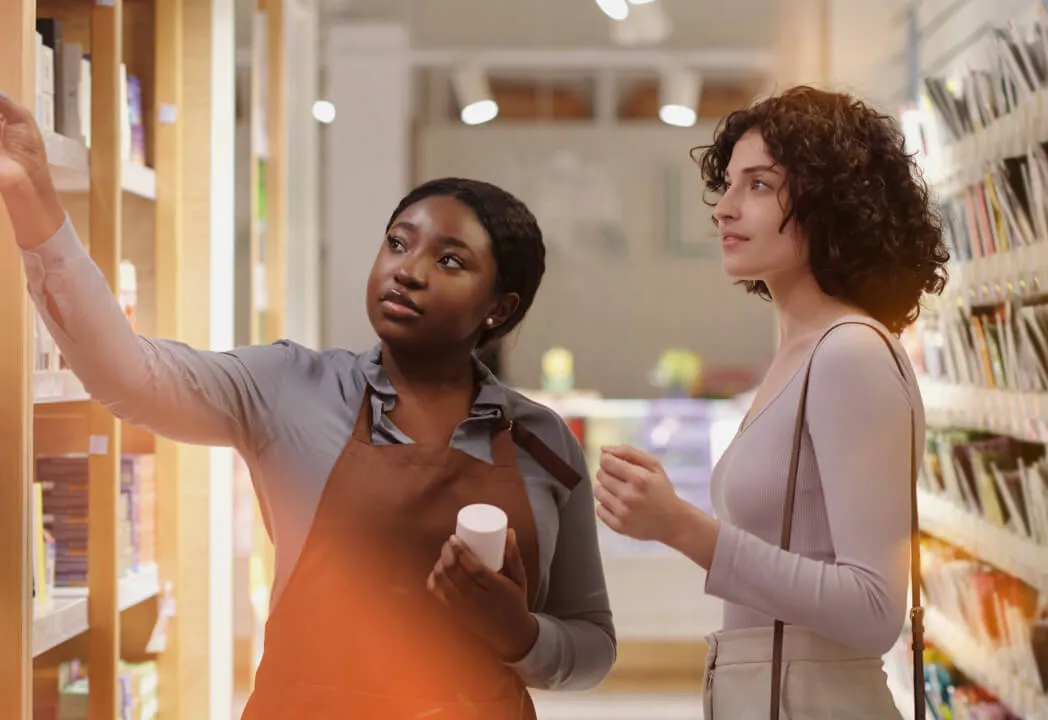 Sales associate helps a customer locate a product