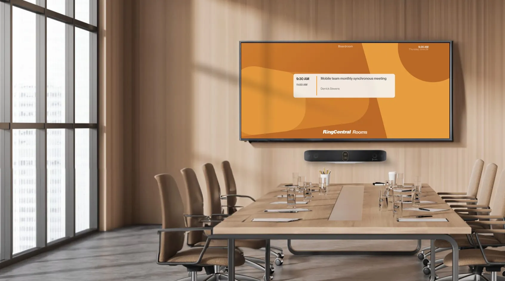 A large conference room fitted with a large screen showing graphs and charts