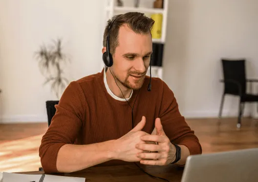 A man attending a video meeting in his home office
