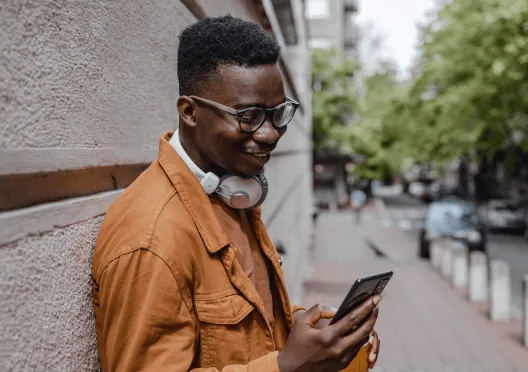 A man checking his phone while outdoors
