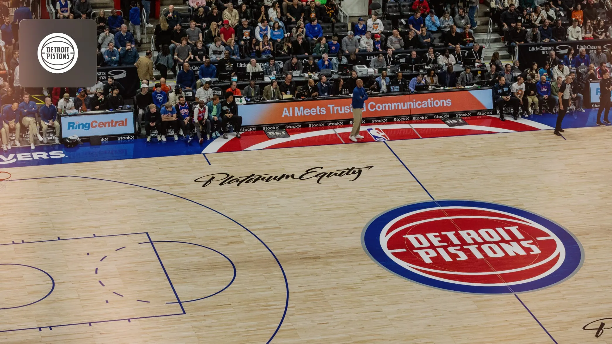 Detroit Pistons players holding a basketball