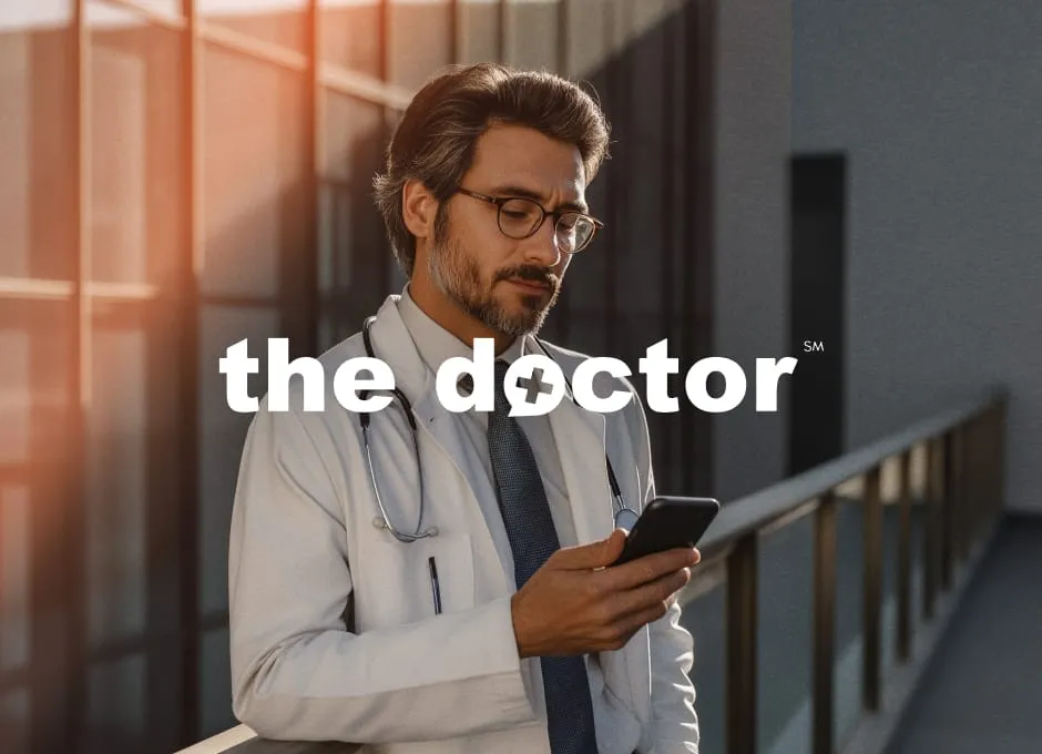 A doctor is using his mobile phone